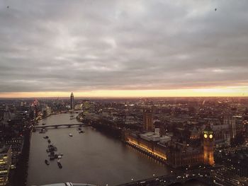 Aerial view of city lit up at sunset