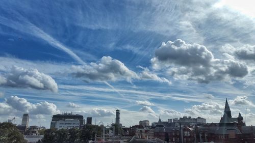 View of cityscape against cloudy sky