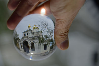 Close-up of hand holding candle