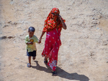 Woman with son walking on land