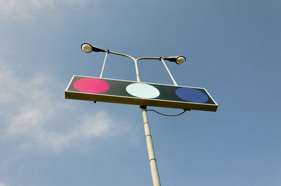 Low angle view of street light against blue sky