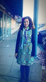 Portrait of smiling young woman standing outdoors