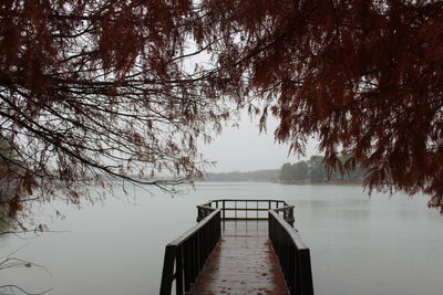 Pier over lake against sky