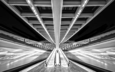 Long exposure bnw night capture on train platform with 2 passing trains