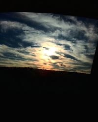 Silhouette landscape against sunset sky