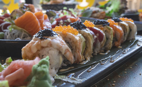 Sushi rolls served on a plate with bamboo leaf in a restaurant