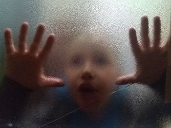 Close-up of boy seen through window