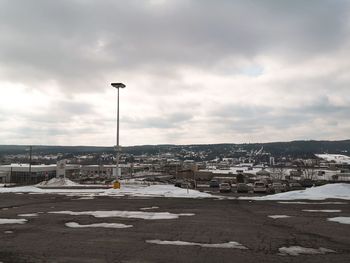 City street by buildings against sky