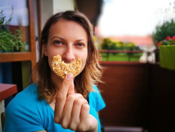 Optical illusion of woman with oatmeal cookie smile at restaurant