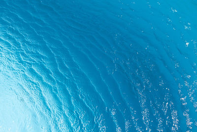 View of surface of turquoise water in swimming pool, sea or ocean, summer background. gradient 