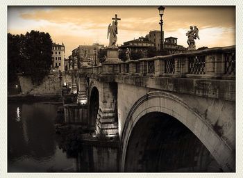 Bridge over river with buildings in background