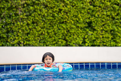 Little adorable girl have fun at outdoor swimming pool