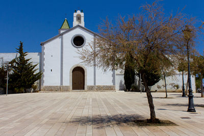 Facade of church against clear blue sky