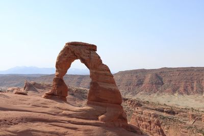 Rock formation in desert against clear sky