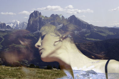 Double exposure of woman and mountains
