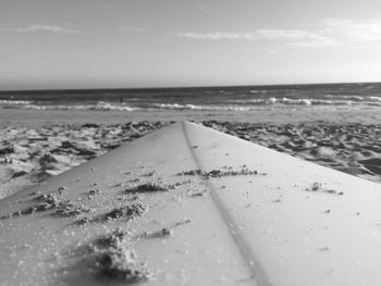 Close up of surfboard on beach