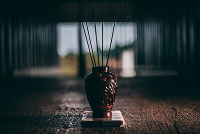 Close-up of illuminated lamp on table at home