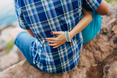 Midsection of woman holding umbrella