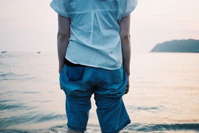 Rear view of man standing on beach