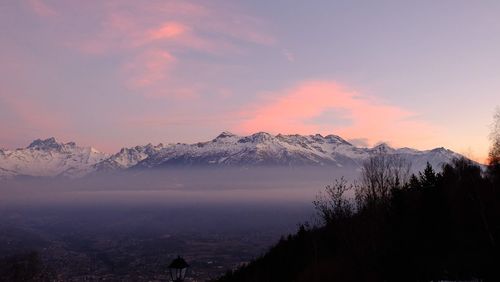 Scenic view of snowcapped mountains against sky during sunset