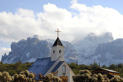 Traditional windmill on mountain against sky