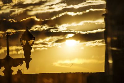 Silhouette statue against sky during sunset