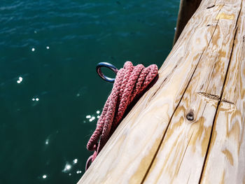 Close-up of rope tied on boat in lake
