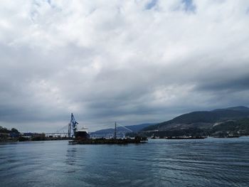 View of ship in sea against cloudy sky