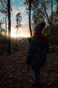 Rear view of man on tree against sky