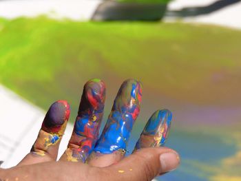 Cropped hand with colorful paint