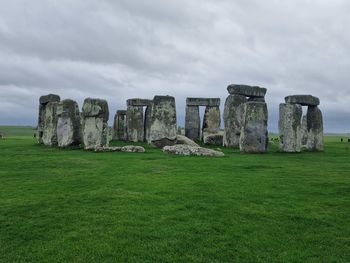 Rock formations on field against sky