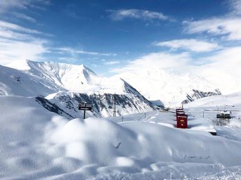 Scenic view of snow covered mountains against sky