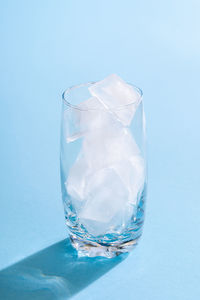 Close-up of glass against blue background