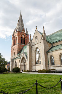 Church by building against sky