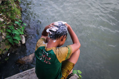 High angle view of boy playing in lake