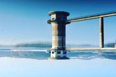 Upside down image of tower over river