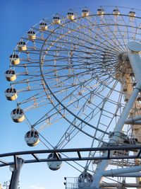 Low angle view of ferris wheel against clear sky