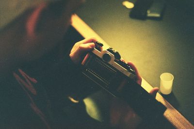 Close-up of man holding analog camera