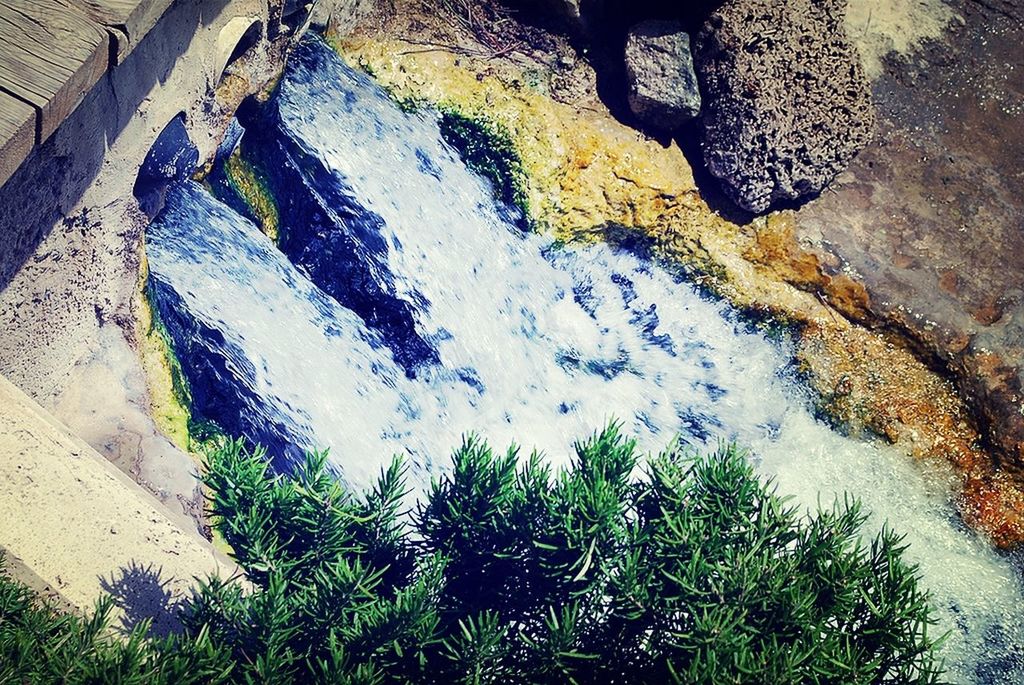 water, high angle view, rock - object, nature, plant, motion, outdoors, day, surf, sunlight, flowing water, beauty in nature, sea, no people, splashing, reflection, stream, waterfall, pond, tranquility