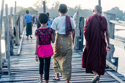 Rear view of people walking outdoors