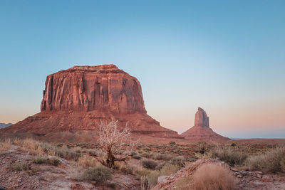 Rock formations on landscape against clear sky