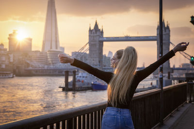 Rear view of woman standing on pier