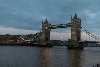 View of bridge over river against cloudy sky