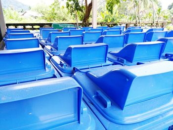 Empty chairs against blue sky