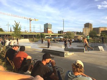 People on road in city against sky