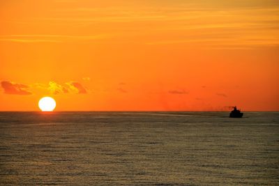 Scenic view of sea against orange sky