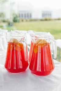 Natural fruit compote in a glass jug at a festive bar