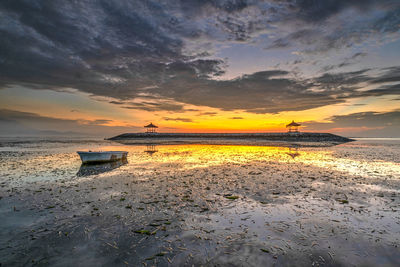 Scenic view of beach against sky during sunset