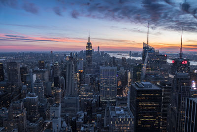 Aerial view of city lit up at sunset