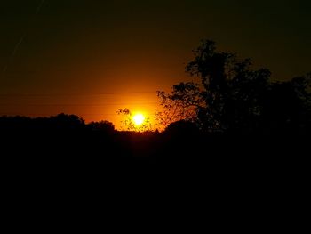 Silhouette trees against sky during sunset